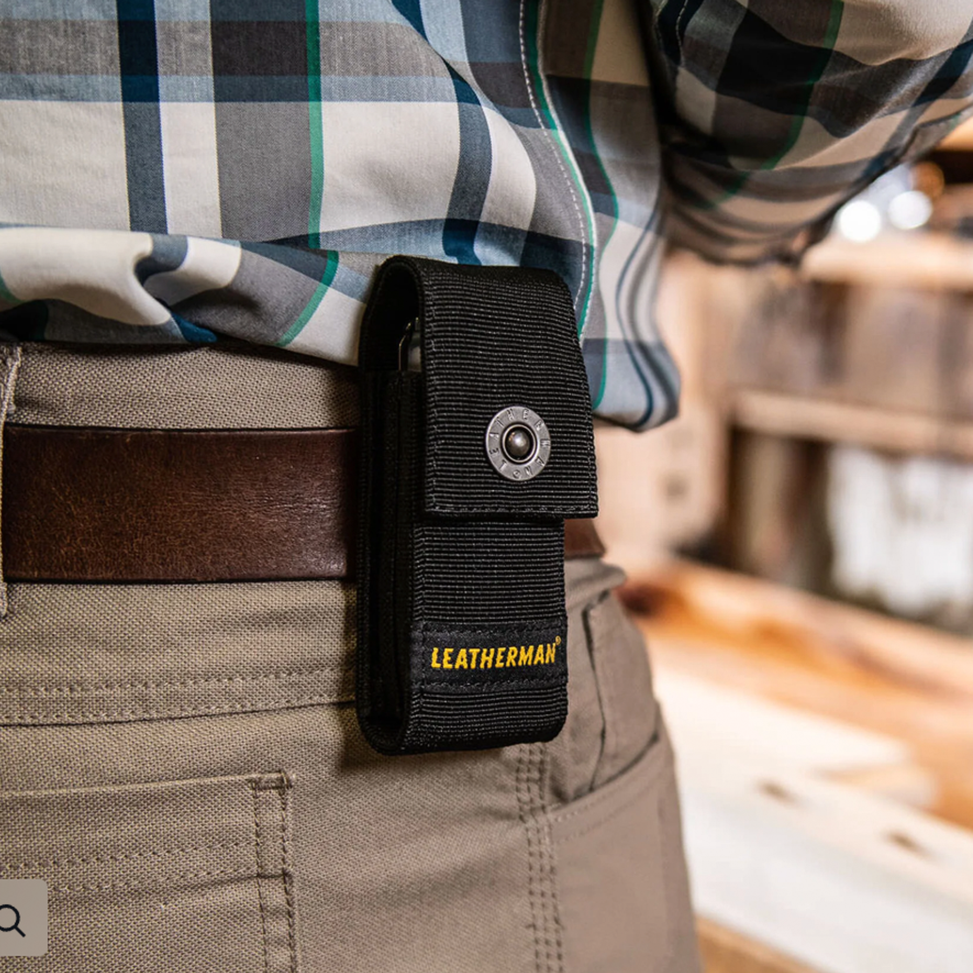 Black Leatherman sheath attached to a person's belt