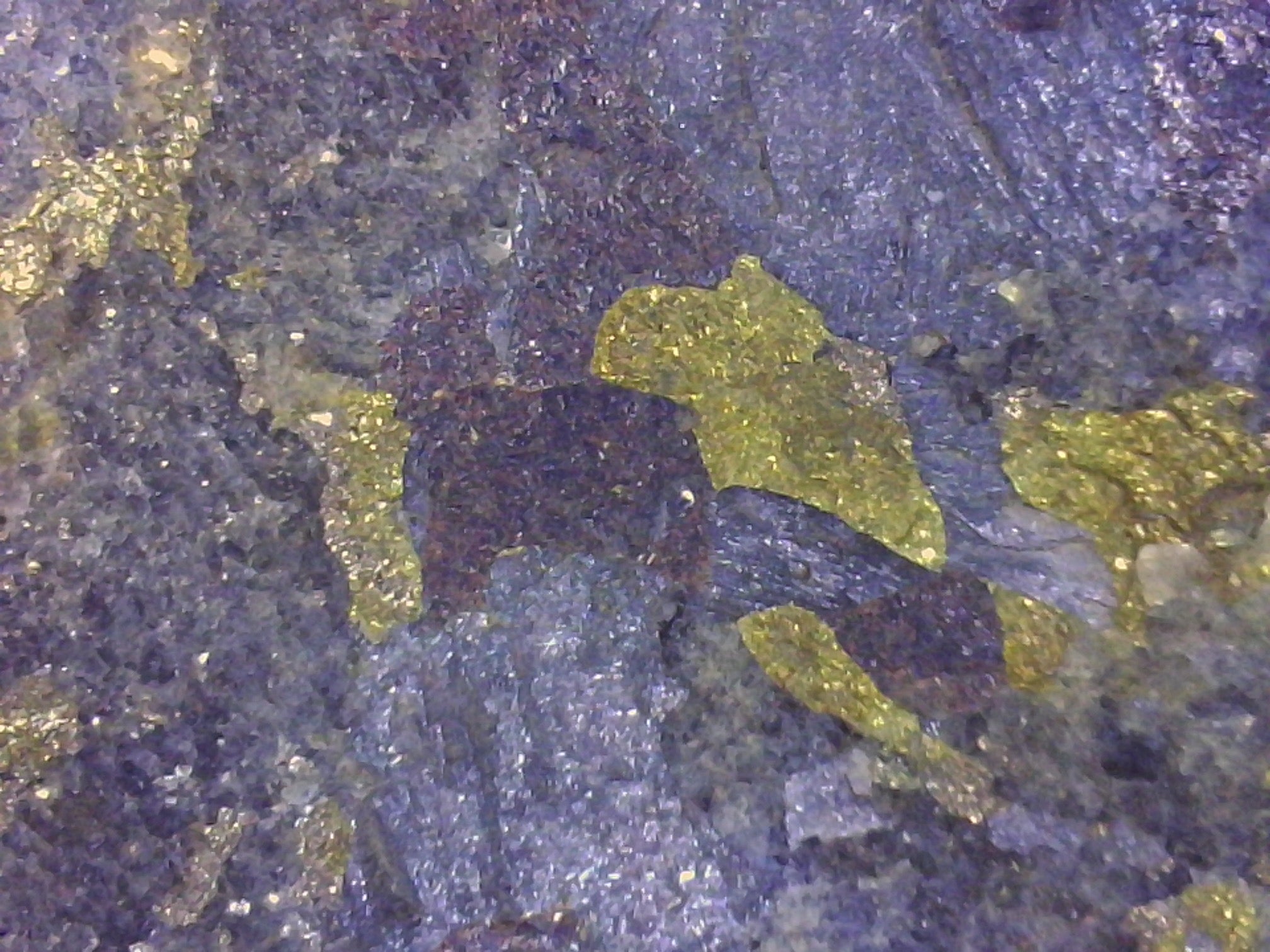 Close-up of a mineral sample with various colors and textures