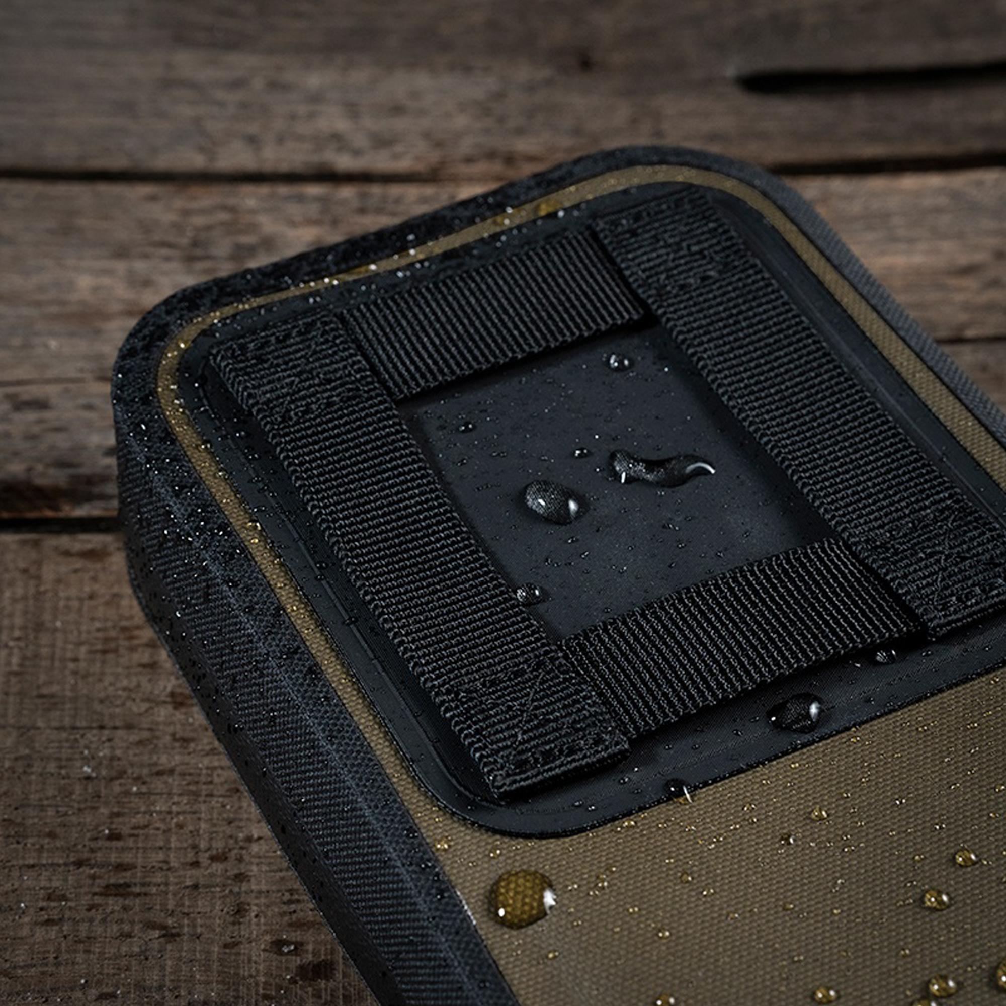 Black belt loop on a brown surface with water droplets