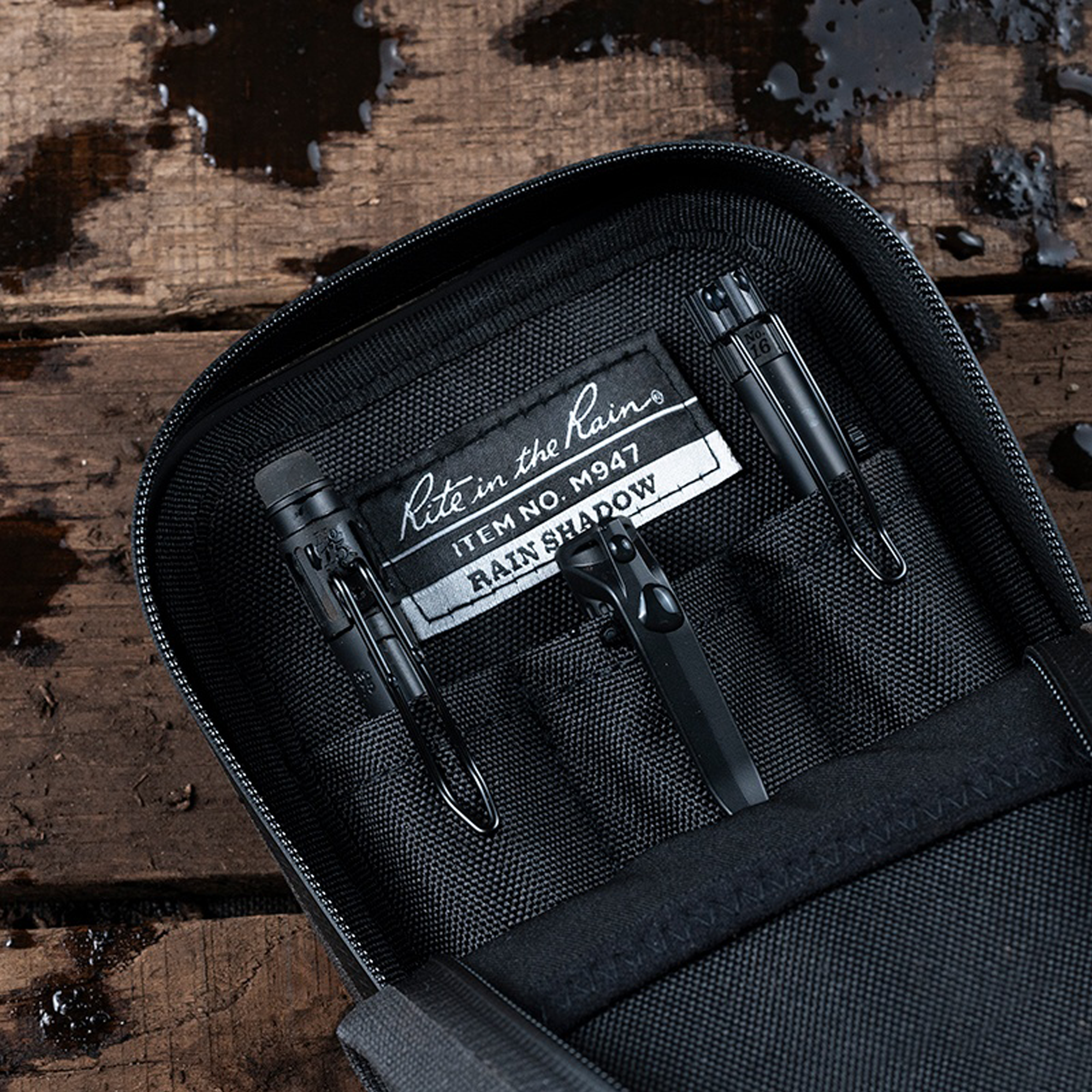 Black tactical pouch on a wooden surface