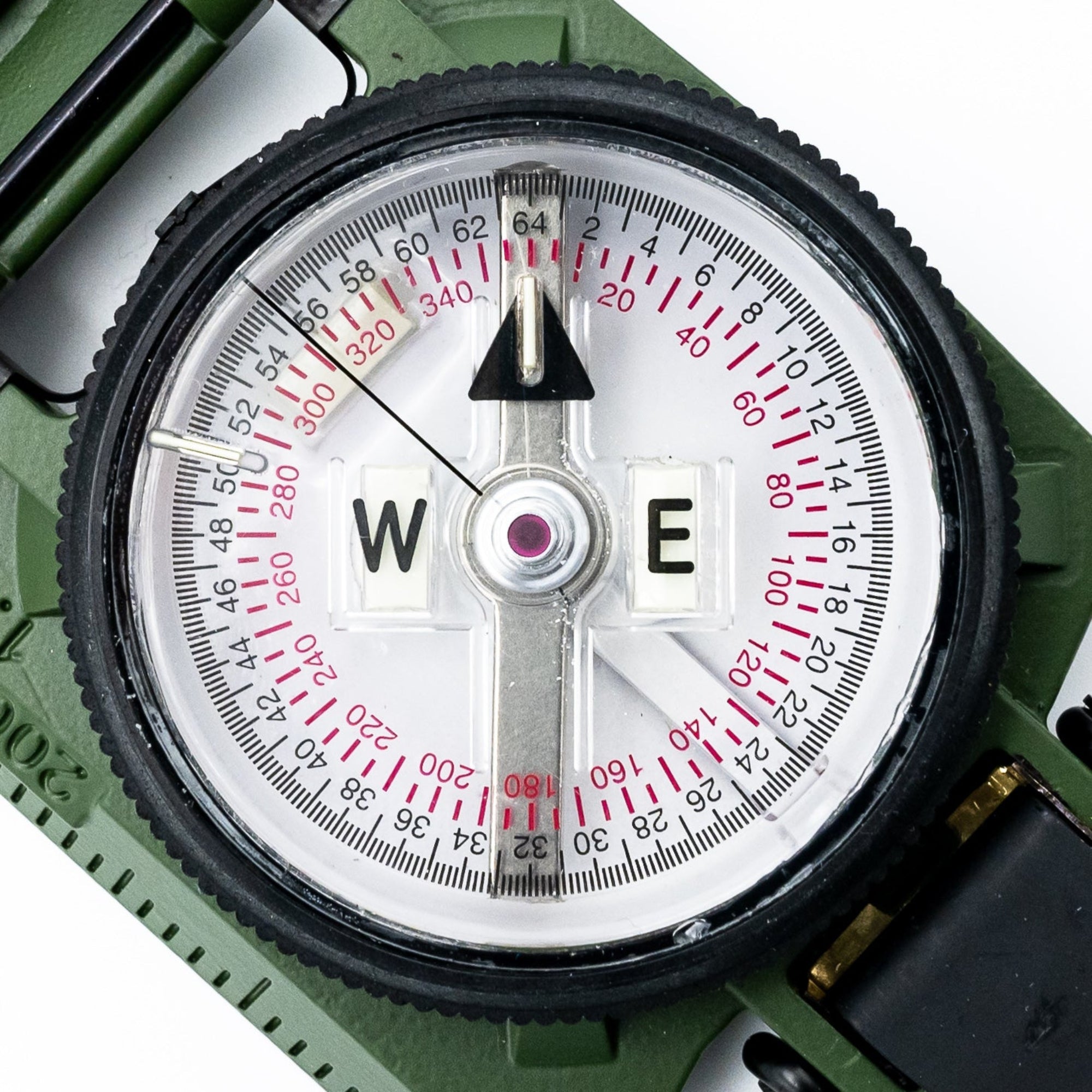 Close-up of a compass with a green casing on a white background