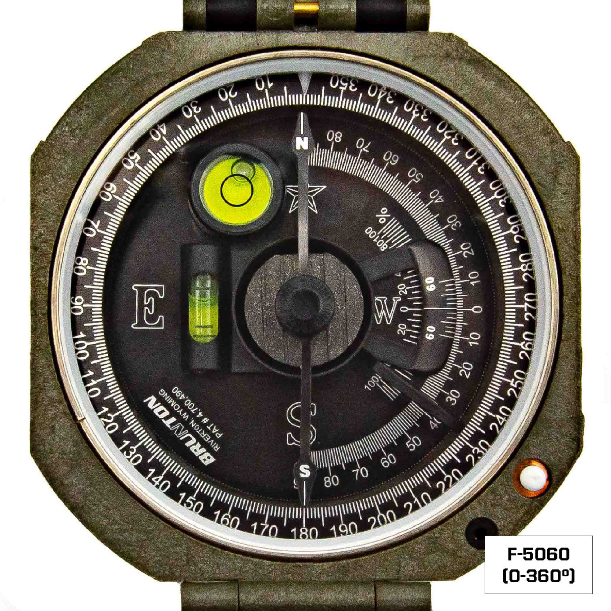 A close-up of a compass with a black dial, white measurement markings, a green bubble level. 